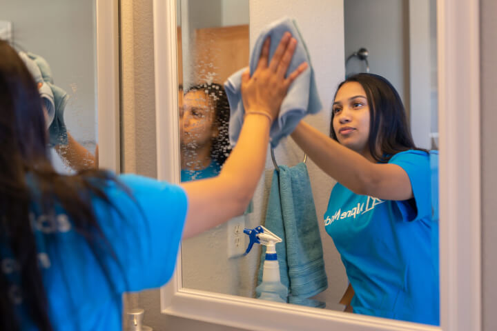 Alpine Maids Cleaning Tech Washing Mirror